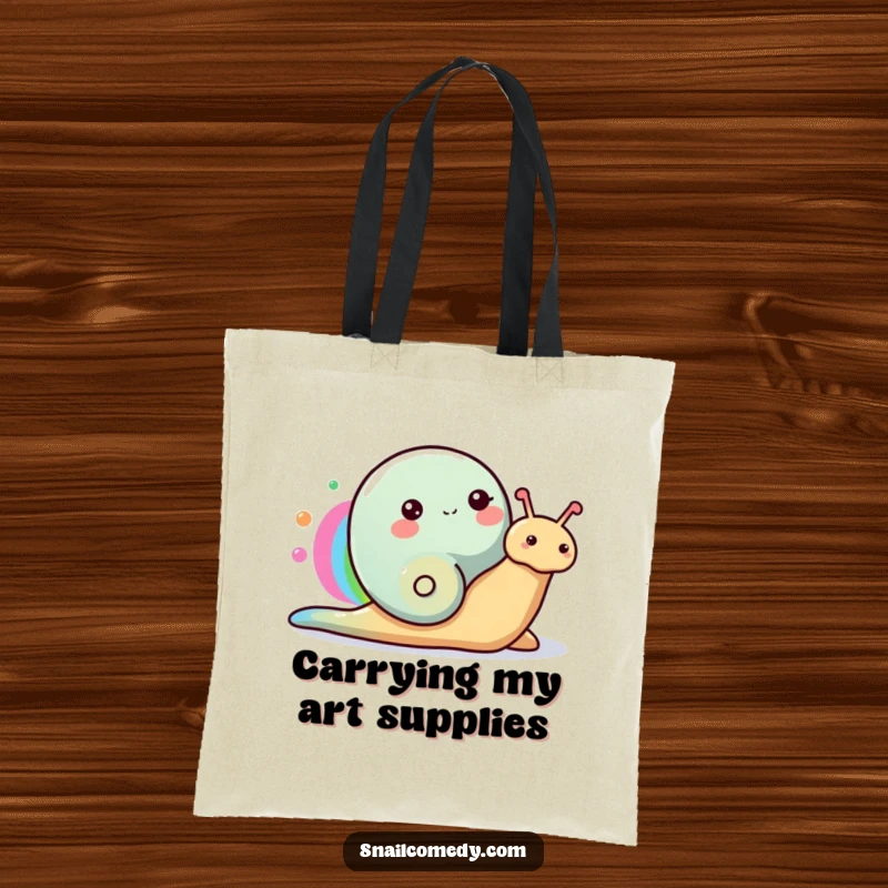 Funny Snail Tote Bag showcasing a happy snail painting a rainbow with its colorful slime trail, perfect for art supplies.